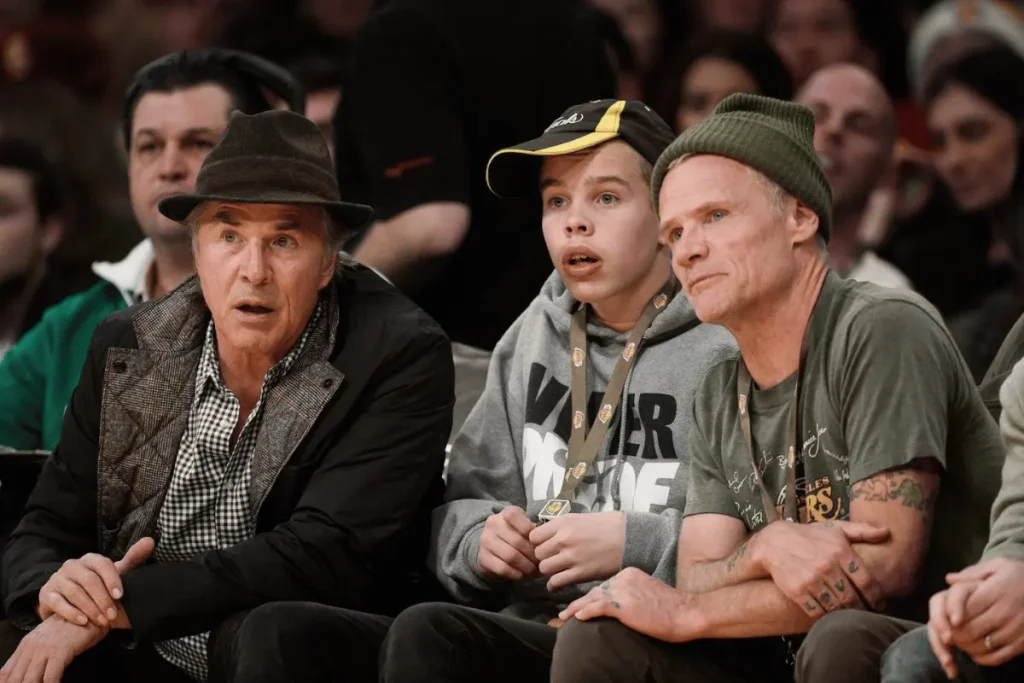 Jasper Breckenridge Johnson sits with Don Johnson at a Dodgers game in a candid father-son photo.