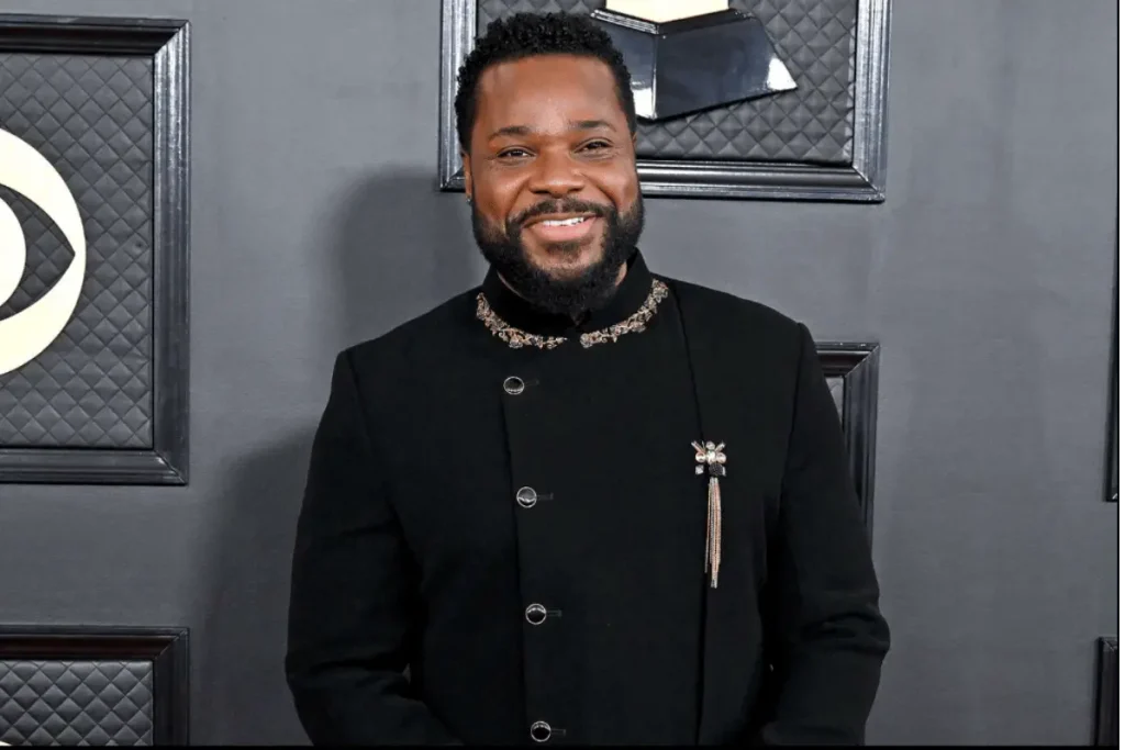 Malcolm-Jamal Warner posing at a public entertainment industry event