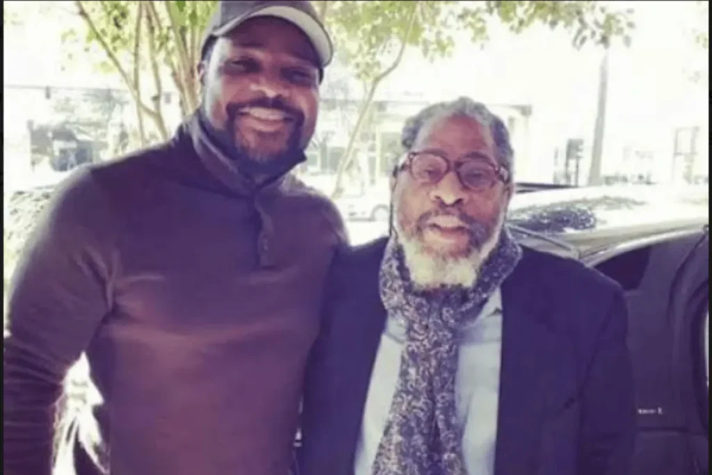 Robert Warner Jr. standing beside Malcolm-Jamal Warner in an outdoor photograph