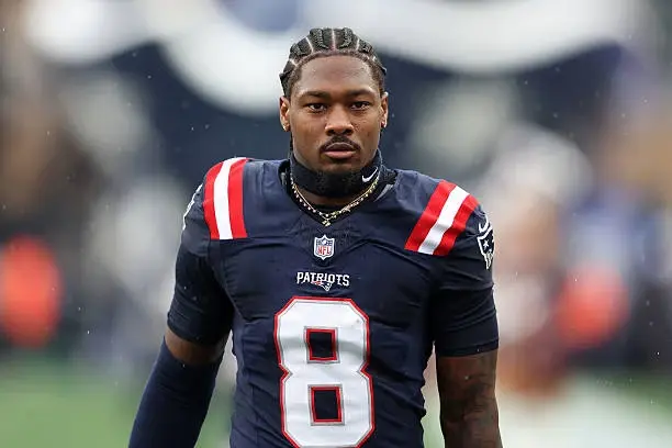 Stefon Diggs wearing a New England Patriots jersey with number 8 on the field