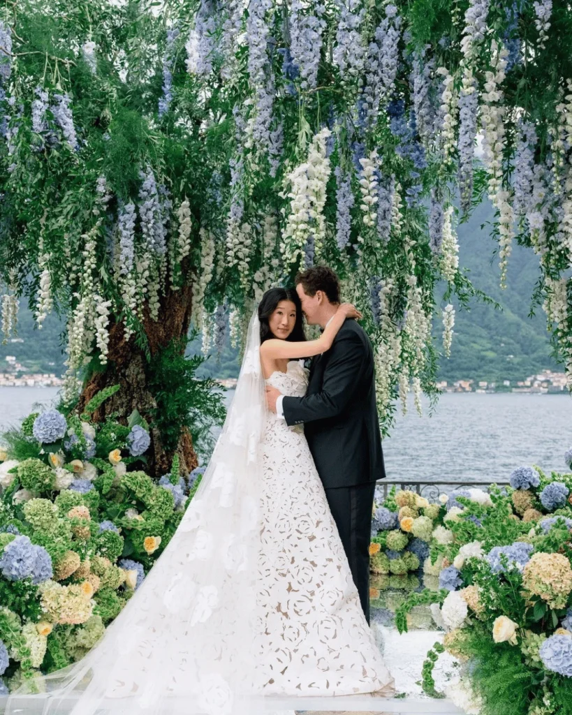 Becca Bloom and David Pownall celebrating their wedding beside Lake Como