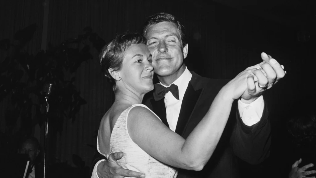Black-and-white photograph of Dick Van Dyke and Margie Willett dancing together at a formal event, with Van Dyke wearing a tuxedo and Willett in a sleeveless dress.