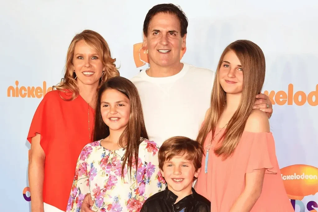 Mark Cuban, Tiffany Stewart, and their children posing together on a red carpet with a Nickelodeon backdrop.