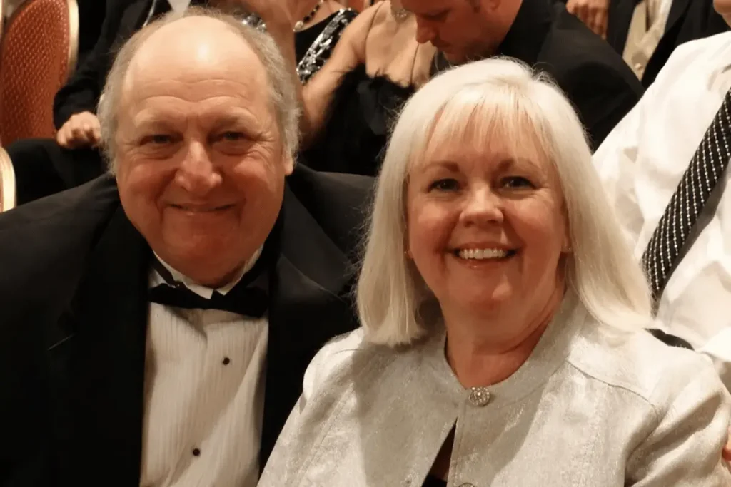 Longtime community figure and "All My Children" actor Paul Avery posing alongside his wife, Sheila Garry Avery, both dressed formally.