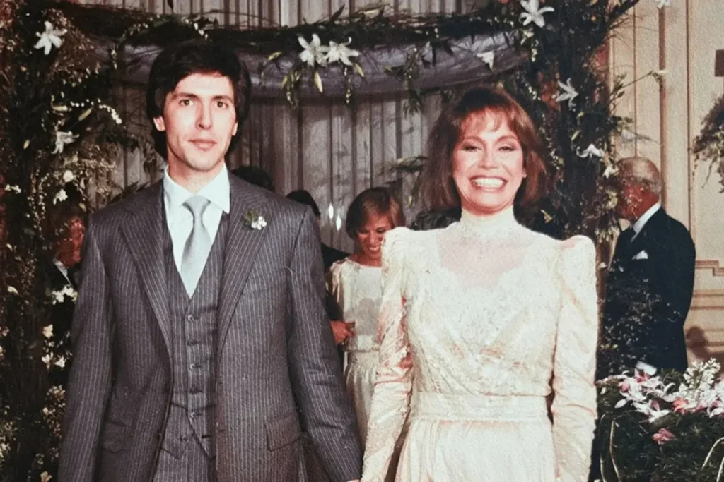 Mary Tyler Moore in her wedding dress standing beside Dr. Robert Levine at their 1983 wedding.