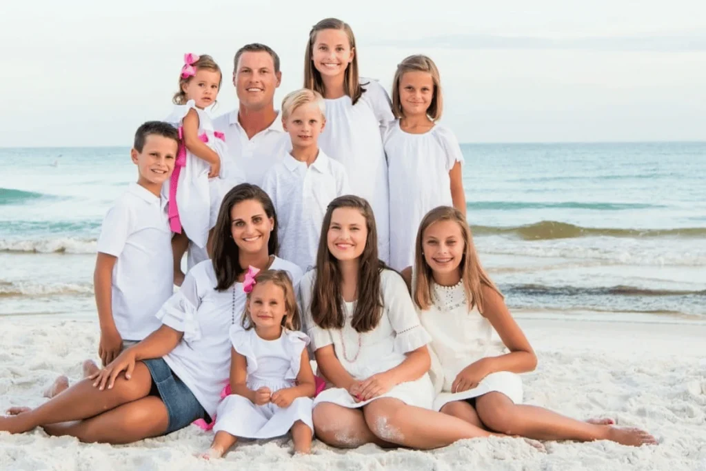 Philip Rivers, Tiffany Rivers and their children posing together on a beach