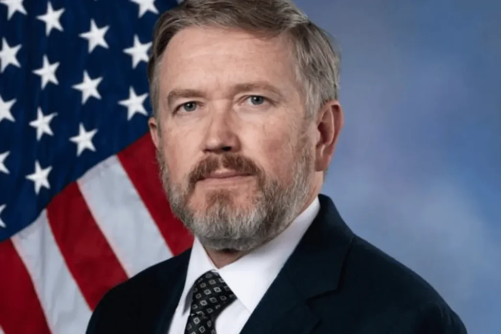 Thomas Massie wearing a dark suit and tie in his official congressional portrait.