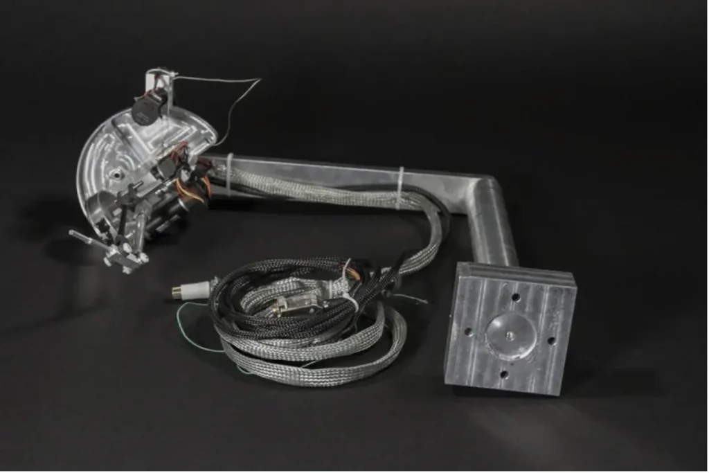 A mechanical PHANToM haptic interface prototype with cables and a curved metal arm assembly.